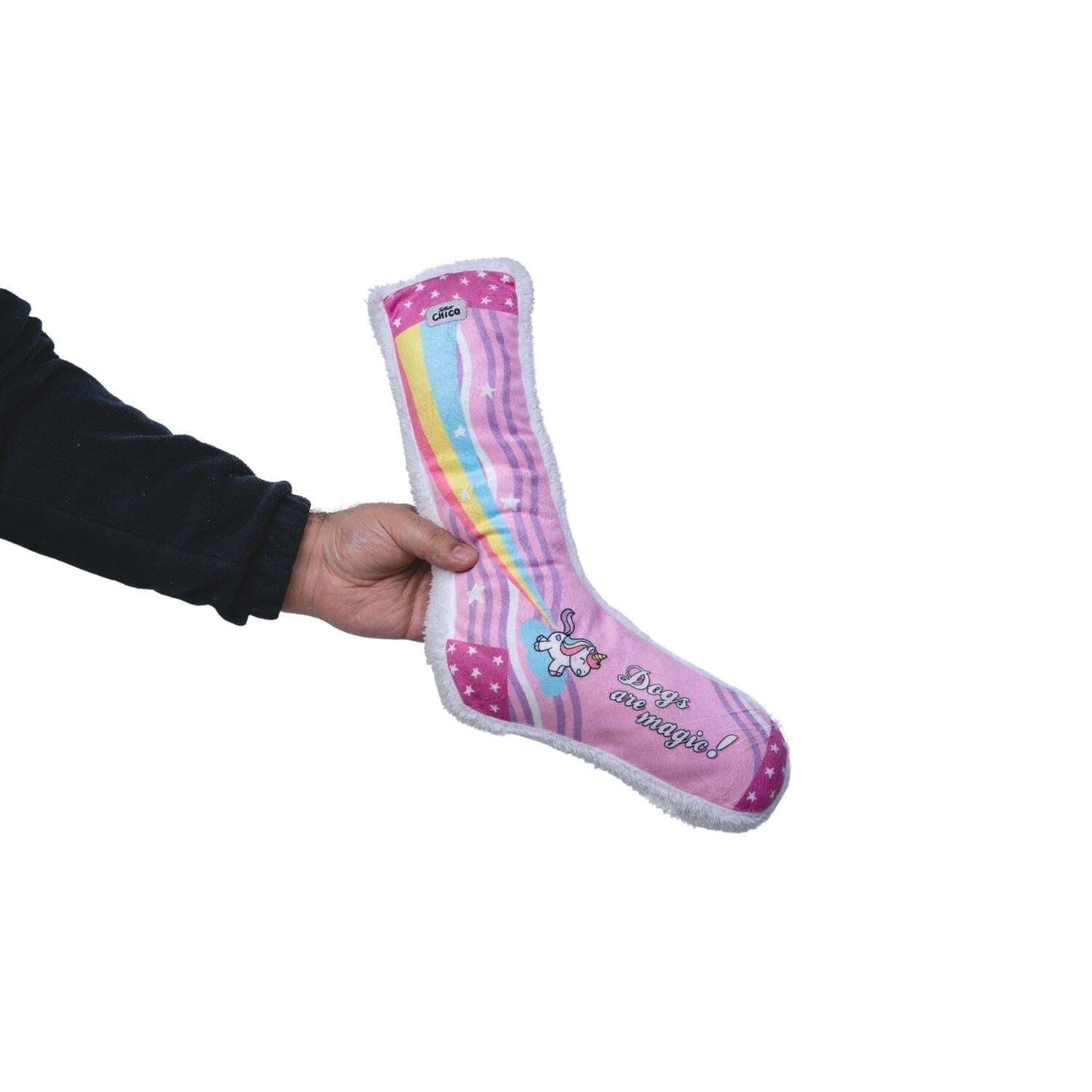 A person holding a pink plush dog toy shaped like a sock with rainbow details and text that says 'You're Magical'