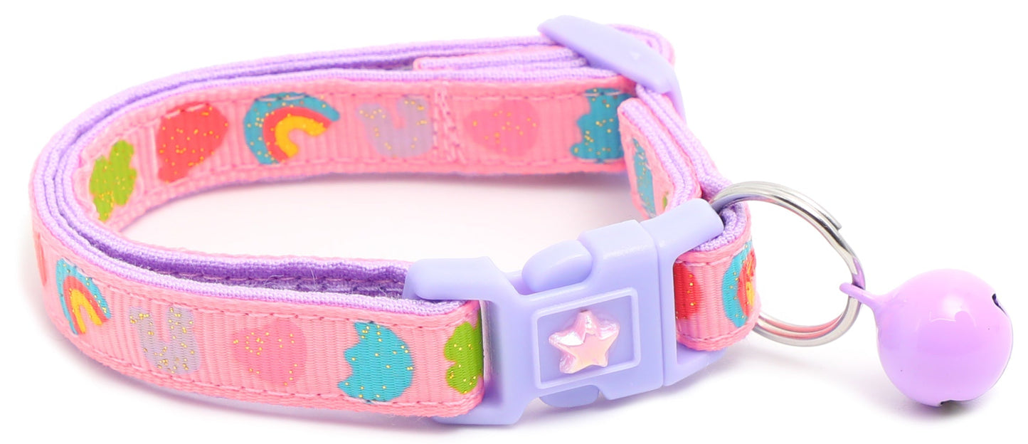 Colorful marshmallow design cat collar featuring vibrant rainbows and hearts on a pink strap