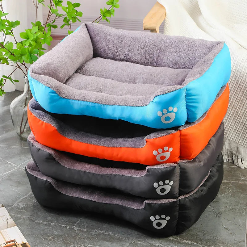 Four colorful pet beds for dogs stacked together, featuring soft materials in blue, orange, and gray