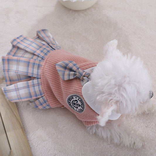 Cozy dog sweater with bow in pink and plaid design worn by small white dog from Purrfect Pet Kingdom