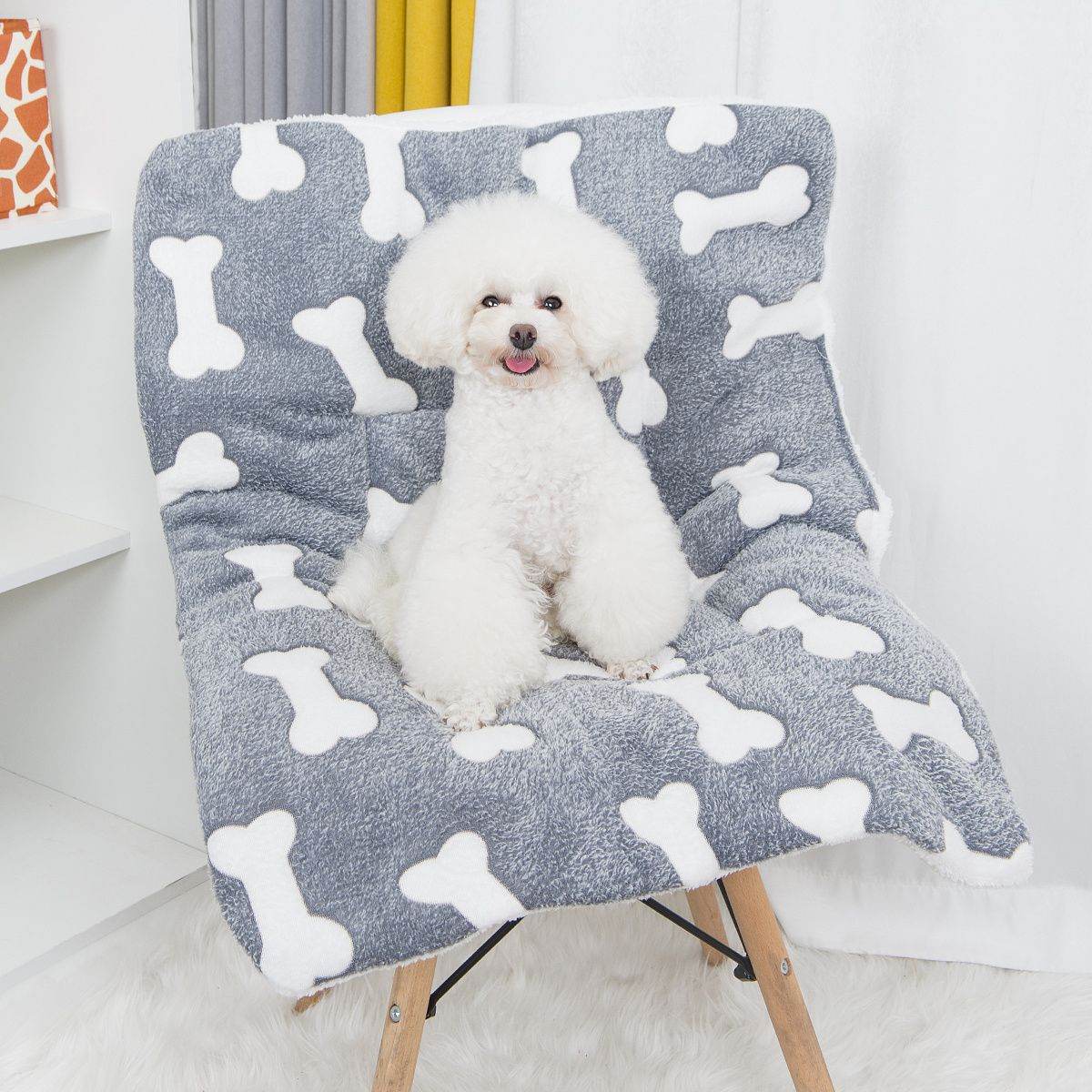 Puppy resting on a cozy orthopedic pet sleeping pad with white bone pattern by Purrfect Pet Kingdom