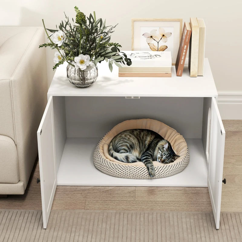 White wooden cat litter box enclosure with open barn doors, side entry hole, and a sleeping cat inside on a pet bed.