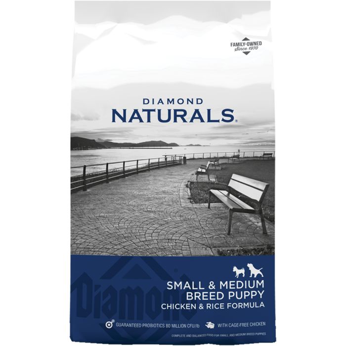 Diamond Naturals small breed puppy food with chicken and rice formula in a bag featuring a scenic background