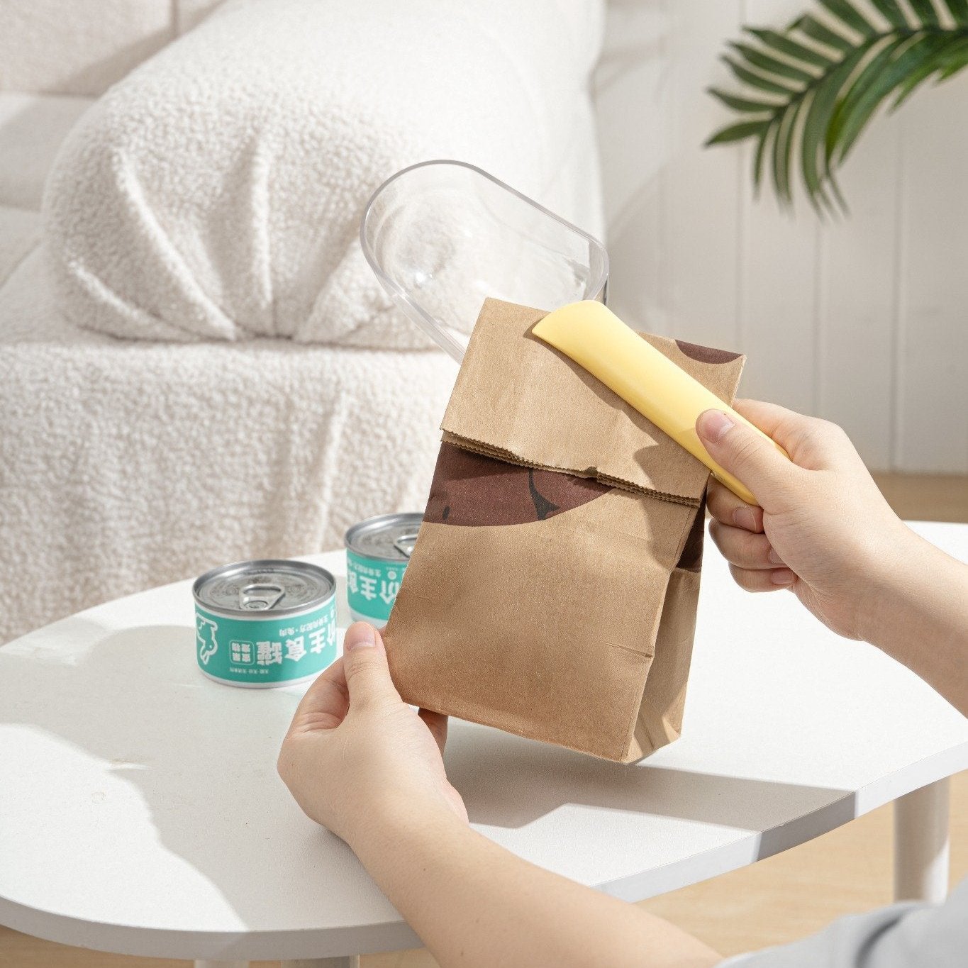 MangoPets dog and cat food serving spoon used for scooping food from a bag on a table