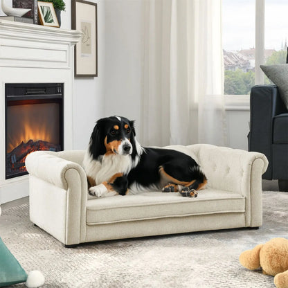 Noble Dog Bed by Purrfect Pet Kingdom with plush cream fabric and rolled arms featuring a black and white dog lying on it near a fireplace