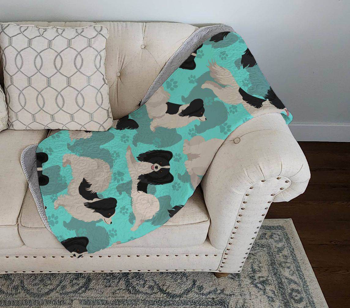 Purrfect Pet Kingdom dog lover gift blanket 50x60 with black and white poodle pattern on teal background draped on beige couch