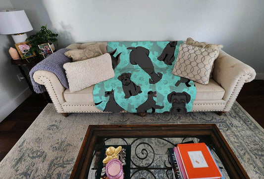Cozy dog lover gift cozy blanket with black dog silhouettes on teal background draped over beige sofa