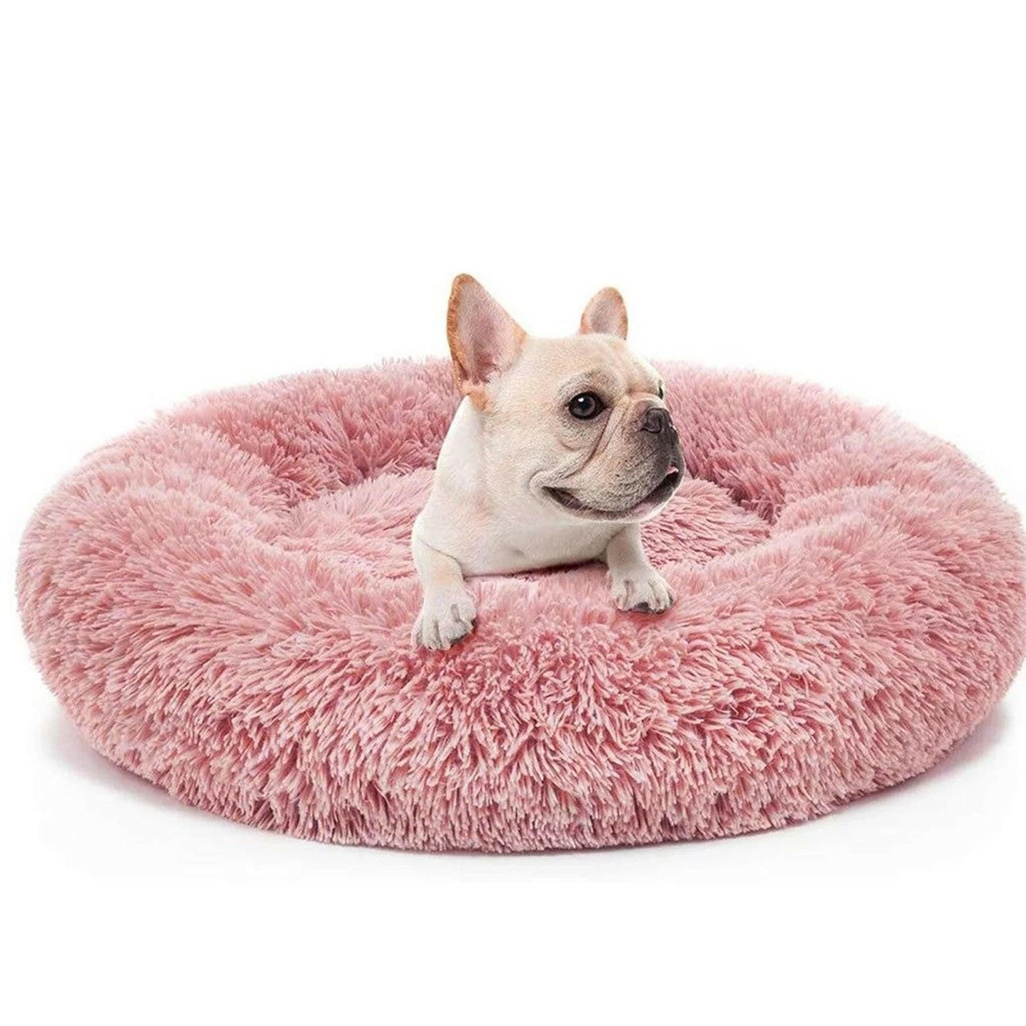 Fluffy donut cat bed in pink with a French Bulldog comfortably resting on it