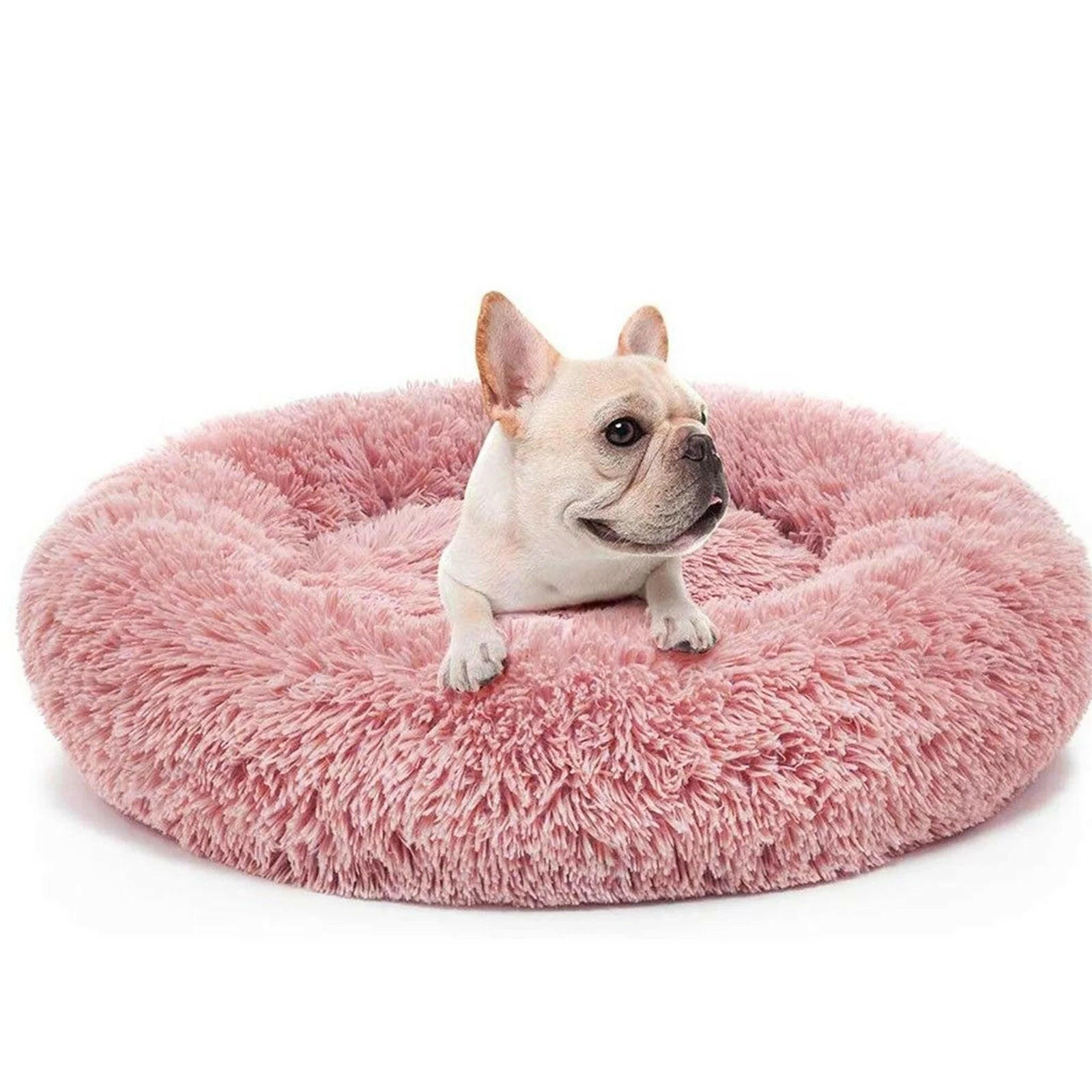 Fluffy donut cat bed in pink with a French Bulldog comfortably resting on it