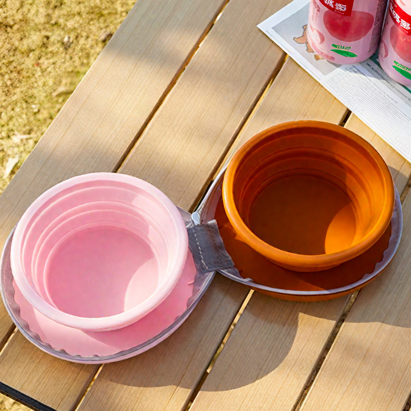 Foldable pet travel bowl in pink and orange, perfect for on-the-go feeding.