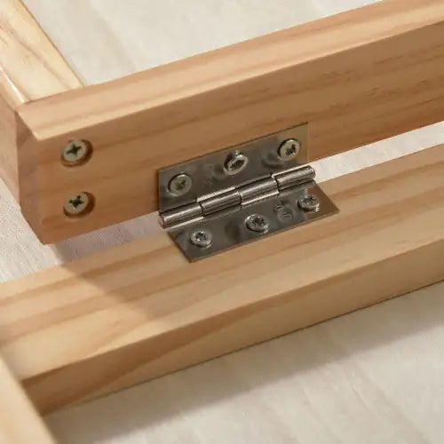 Close-up of a foldable ramp for pets showcasing durable wood construction and sturdy hinges