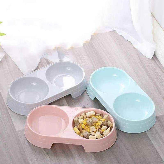 Purrfect Pet Kingdom dual pet feeding bowls in pink, blue, and gray, with one bowl filled with pet food