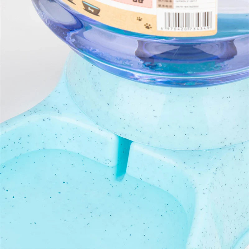 Gravity pet water and food dispenser with a blue base and clear water reservoir for pets
