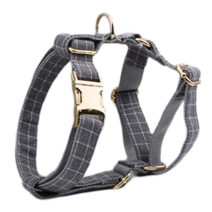Purrfect Pet Kingdom gray plaid fabric dog harness featuring gold metal hardware and adjustable straps for puppies.