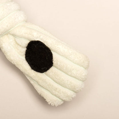 White ribbed plush fabric with a black spot on a Purrfect Pet Kingdom Jonny Justice interactive enrichment dog toy.