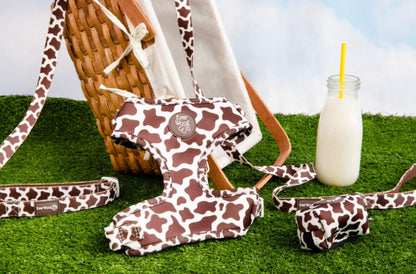 Chocolate Cow Print Adjustable Dog Harness for Daily Walks by Purrfect Pet Kingdom. Brown cow print set on green grass.