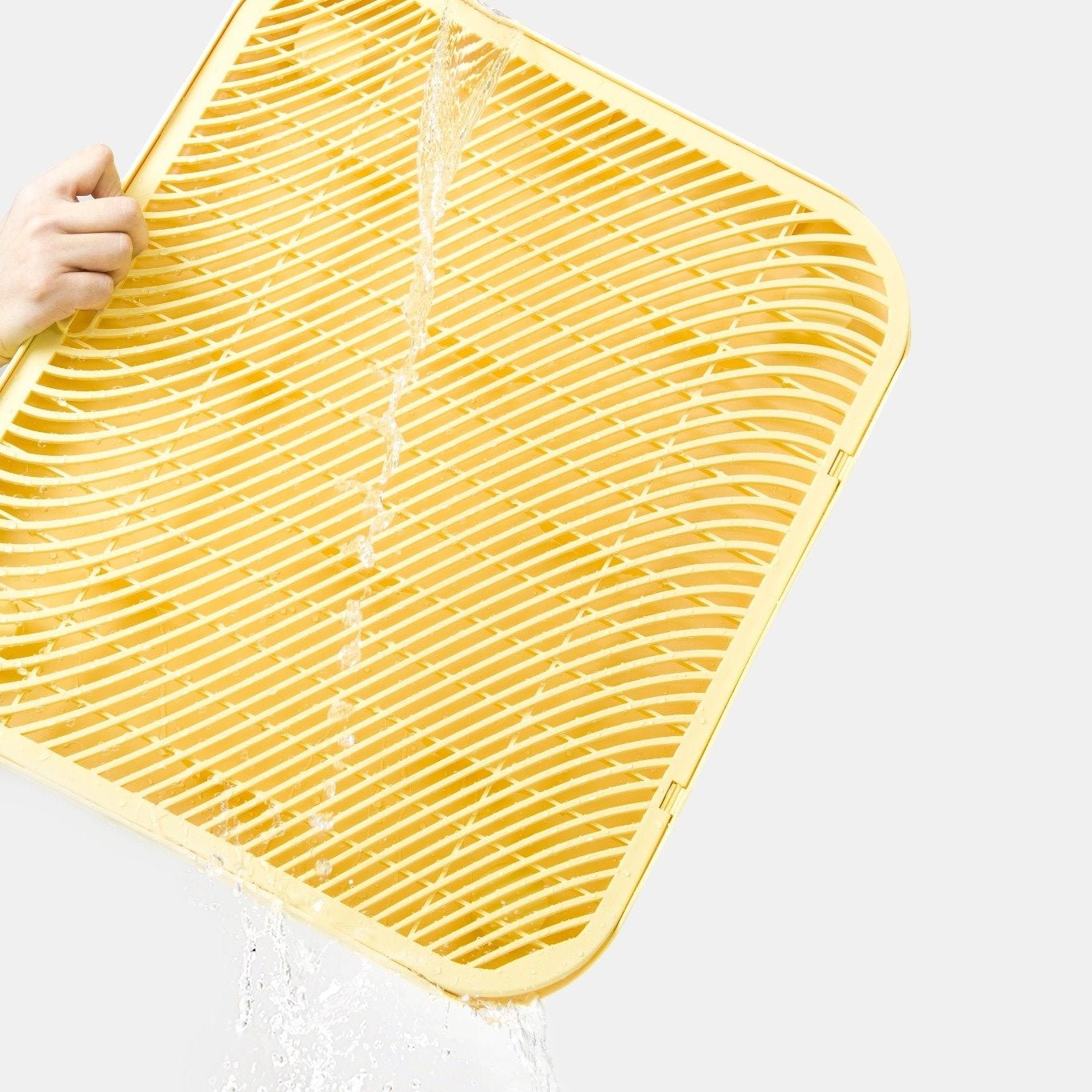 MangoPets Cat Litter Mat in Yellow being washed, the best mat for cat litter box