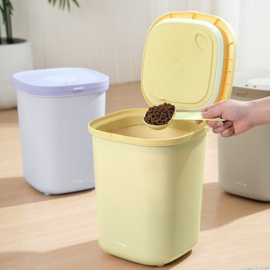 MangoPets large capacity dog food container in yellow with a lid opened, holding dry dog food