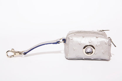 BESPOKE PAWS silver ostrich-print dog poop bag dispenser with a metal clip and round dispensing outlet.