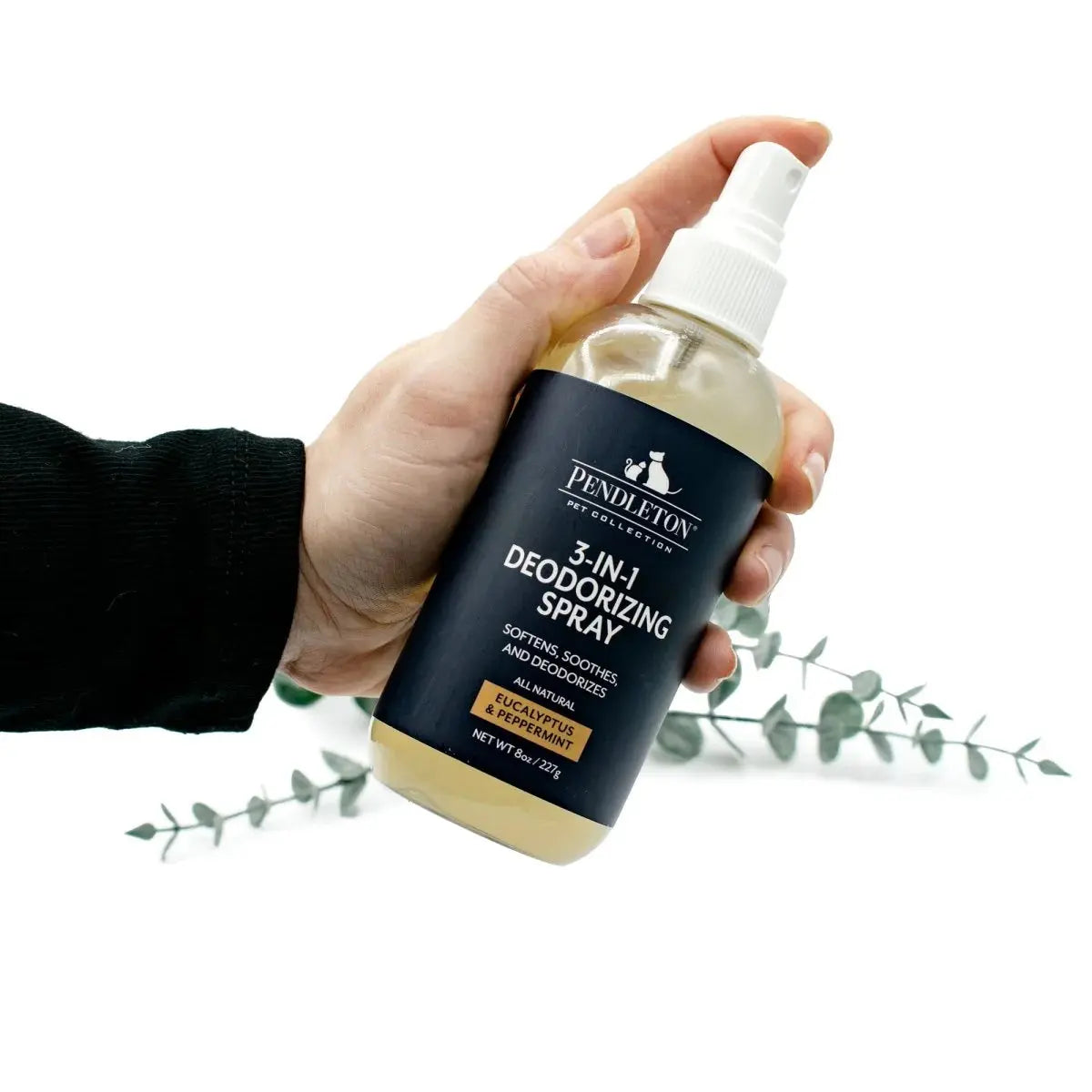 Pendleton pet deodorizer spray in a hand, ideal for soft surfaces and removing pet odors