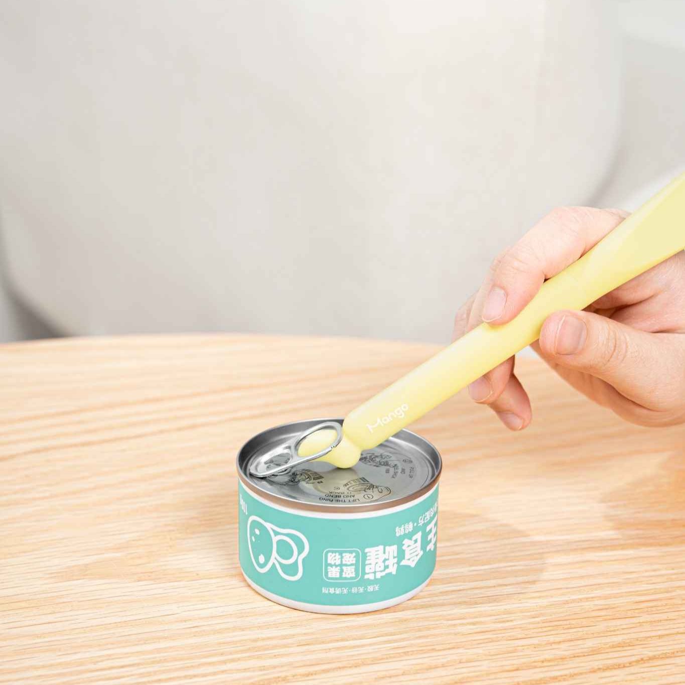 MangoPets pet food can spoon in use on a can, perfect for serving pet meals easily and mess-free
