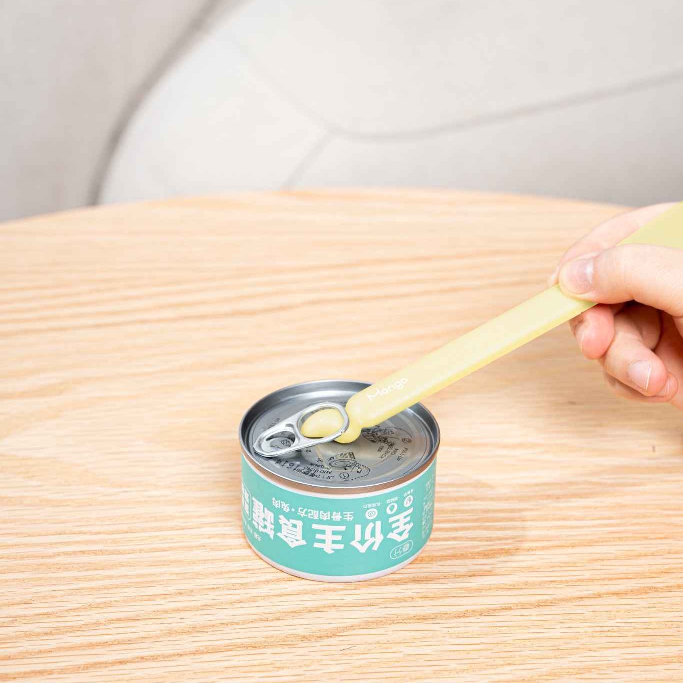 MangoPets pet food can spoon in use with a can, designed for easy feeding of pets