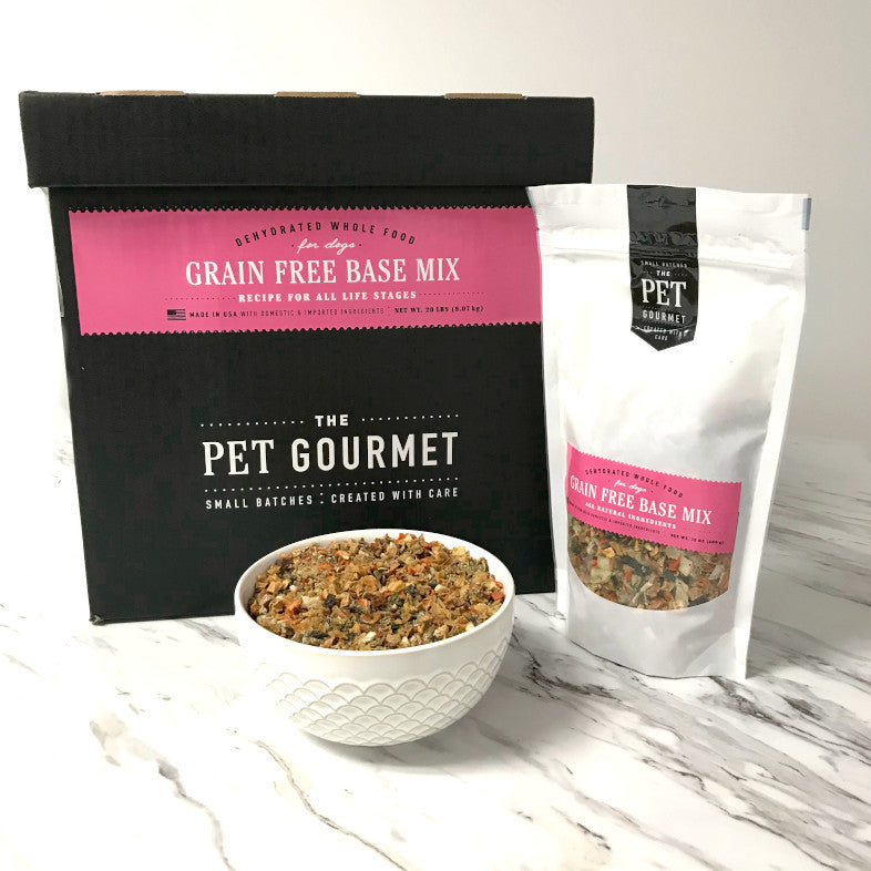 The Pet Gourmet grain free dog food premix in a bowl with packaging and box on a marble surface