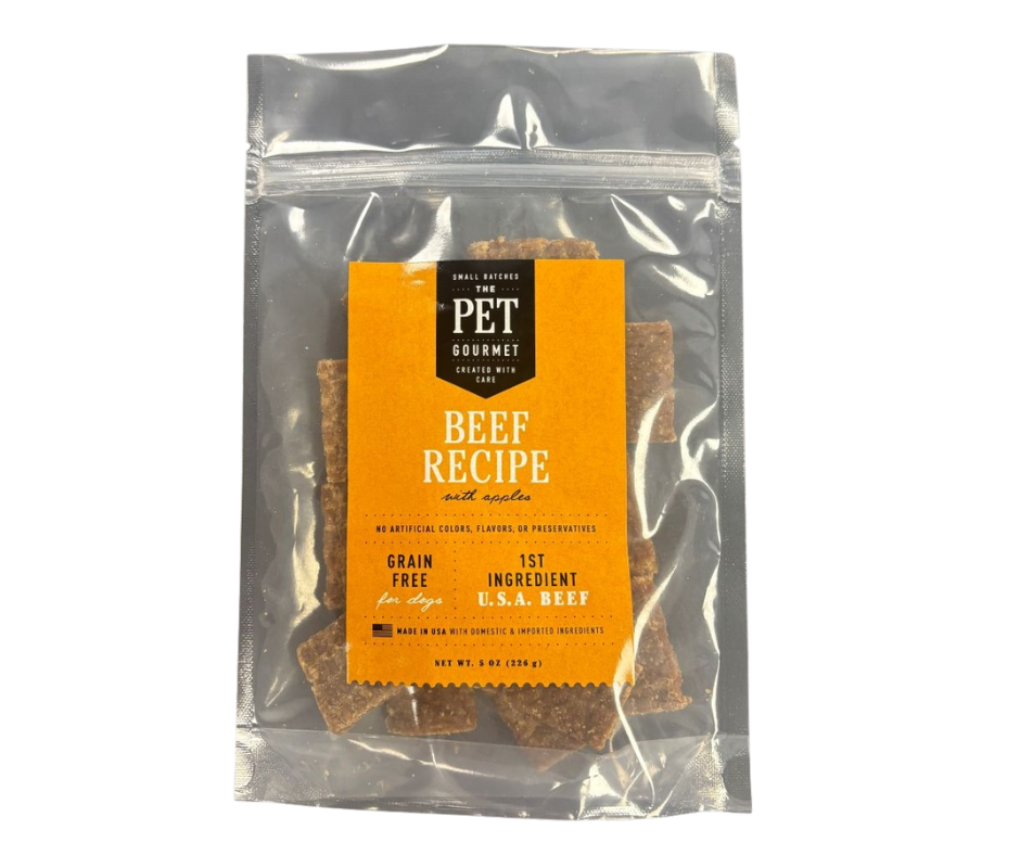The Pet Gourmet healthy beef dog snacks in a clear bag with a bright orange label and grain-free recipe