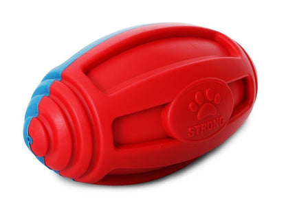 Red and blue Pet Life TPR football dog toy with durable textured grooves and a "STRONG" paw print logo.