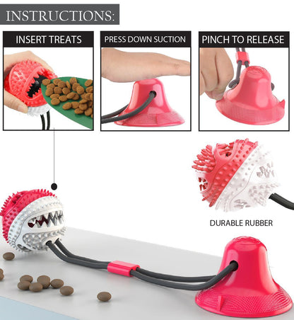 Red & white Pet Life rubber treat orb dog toy featuring a suction cup base, gray rope, and enrichment instructions.