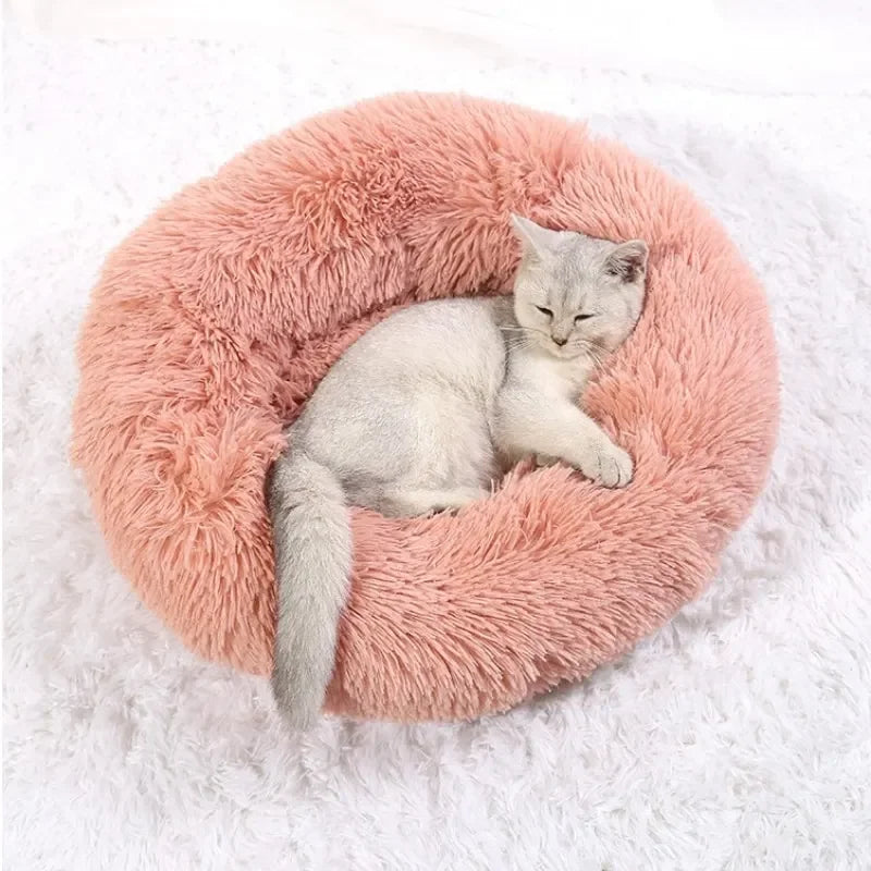 Cozy round plush dog bed for anxiety in soft pink, perfect for calming pets and providing comfort