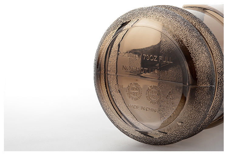 Durable bottom view of a portable hydration jug for workouts with a textured grip design