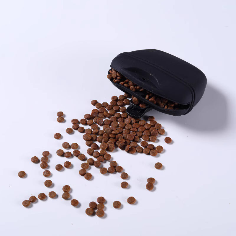 Portable pet treat pouch opened with pet treats spilling out on a white background