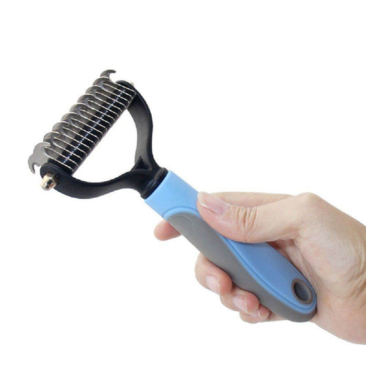 Purrfect Pet Kingdom professional pet dematting comb with ergonomic blue and gray handle held in hand