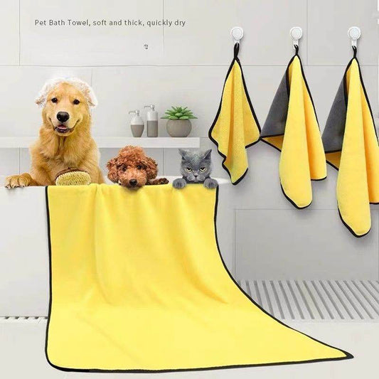 Purrfect Pet Kingdom quick drying dog towel in yellow hanging and draped over bathtub with dogs and cat