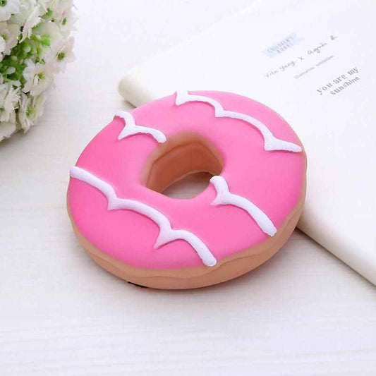 Pink donut-shaped royal chompers interactive pet toy with white icing details from Purrfect Pet Kingdom