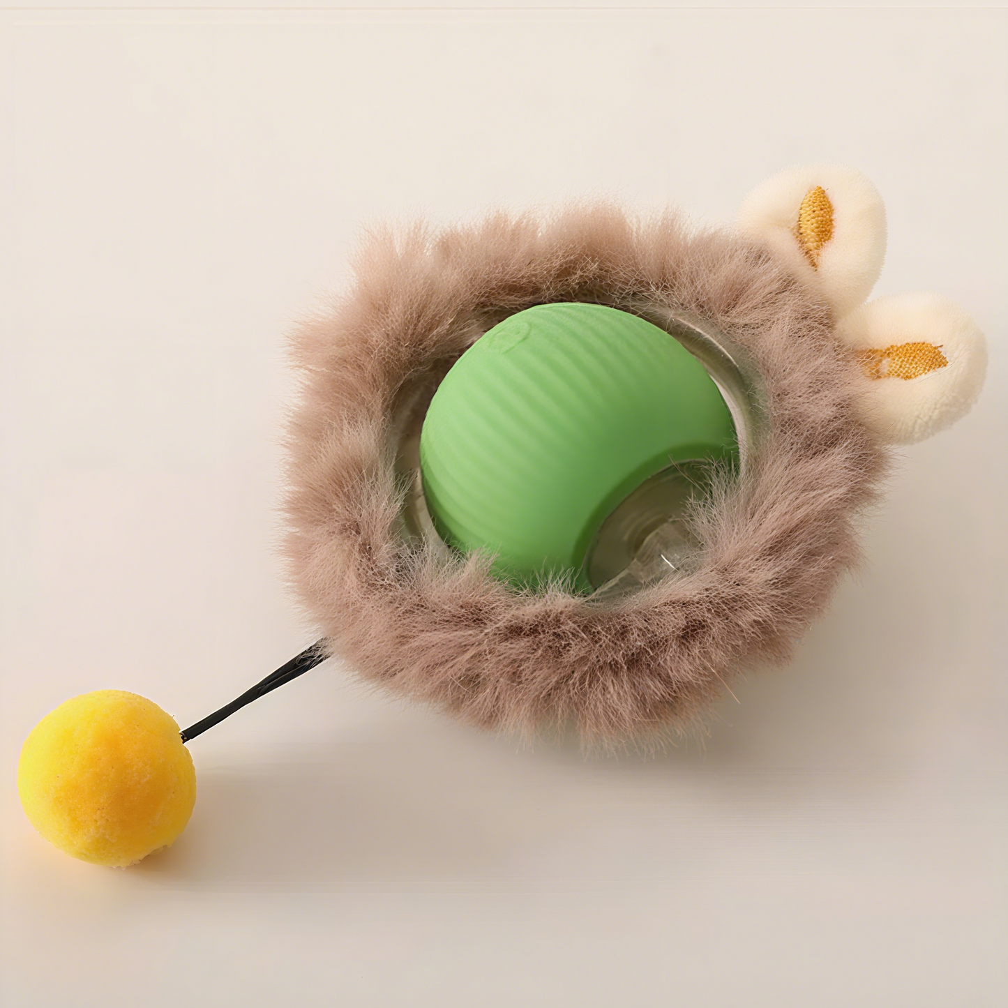 Smart interactive cat toy ball with fluffy exterior and bright yellow pom-pom for playful kittens