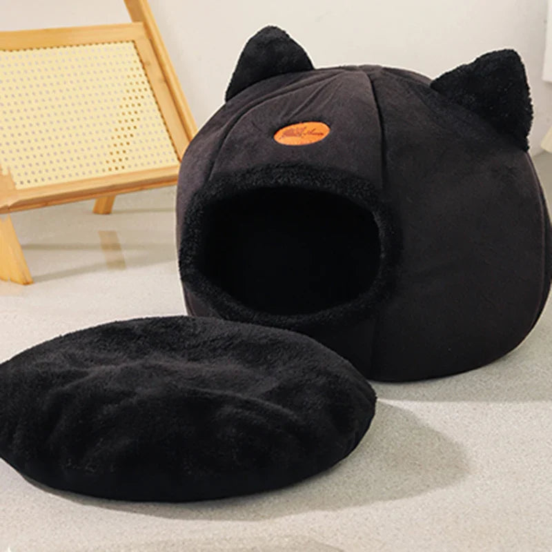 Cozy black cat cave by Purrfect Pet Kingdom, a soft cat bed for cold weather featuring a removable cushion.