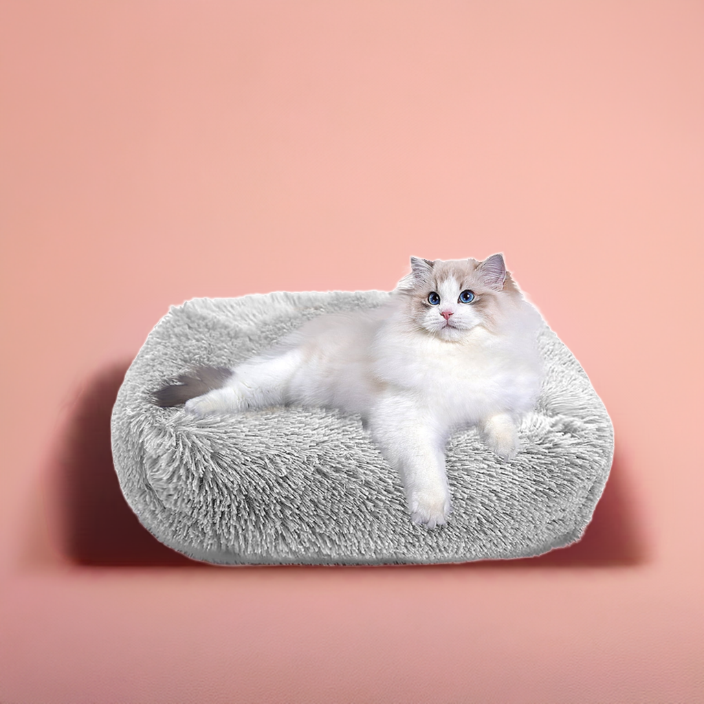 Soft cozy cat bed in grey with fluffy texture, perfect for providing comfort for your feline friend.