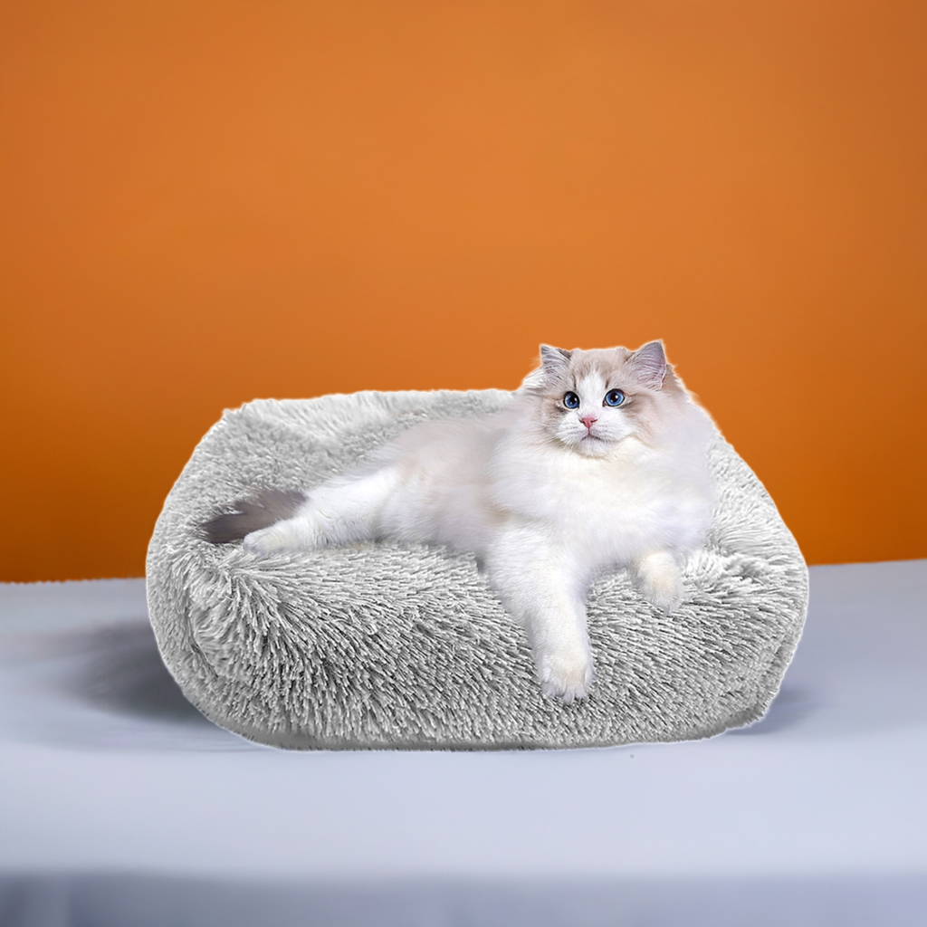 Fluffy soft cozy cat bed designed for ultimate comfort with a relaxed cat lounging on it