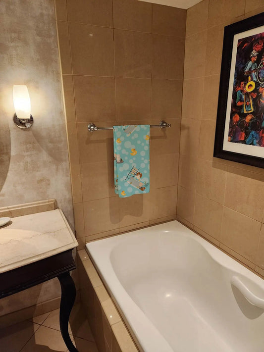Soft pet towel for small dogs hanging on bathroom towel rack above white bathtub