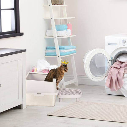 Cat using a traditional high-sided litter box in a bright laundry room featuring the stainless steel cat litter box