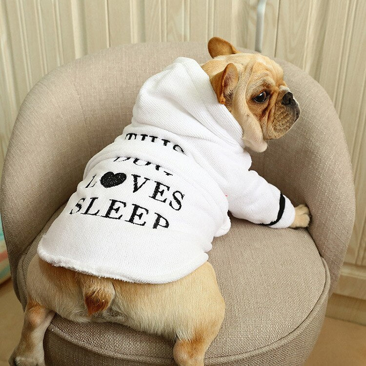 Cute dog wearing a white hooded bathrobe with black text for pet grooming or drying