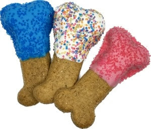 Three dog toys shaped like bones in blue, multicolored, and pink with cork bases on a white background.