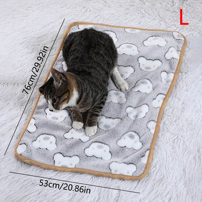 Cozy cat lying on Purrfect Pet Kingdom warming pet pad for cats and dogs with cloud pattern