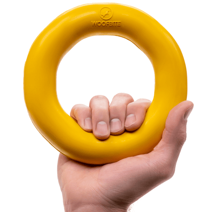 Monster K9 Durable Dog Toy in Yellow, sturdy ring shape held in hand for tough playtime