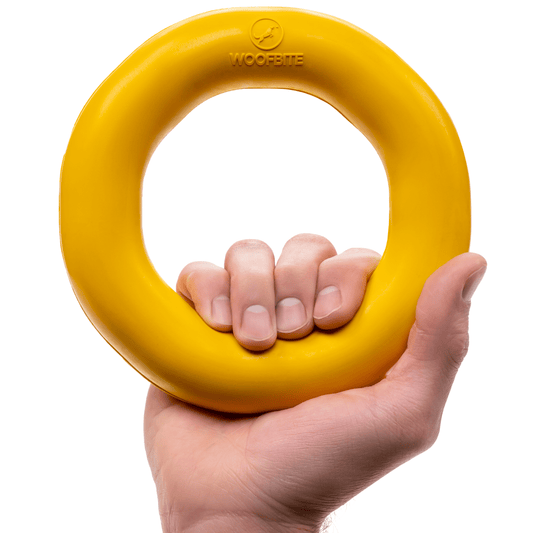 Monster K9 Durable Dog Toy in Yellow, sturdy ring shape held in hand for tough playtime