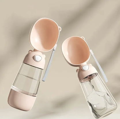 Two Mimarta pink travel dog water bottles with attached bowls, bear-ear caps, clear bodies, and wrist straps.